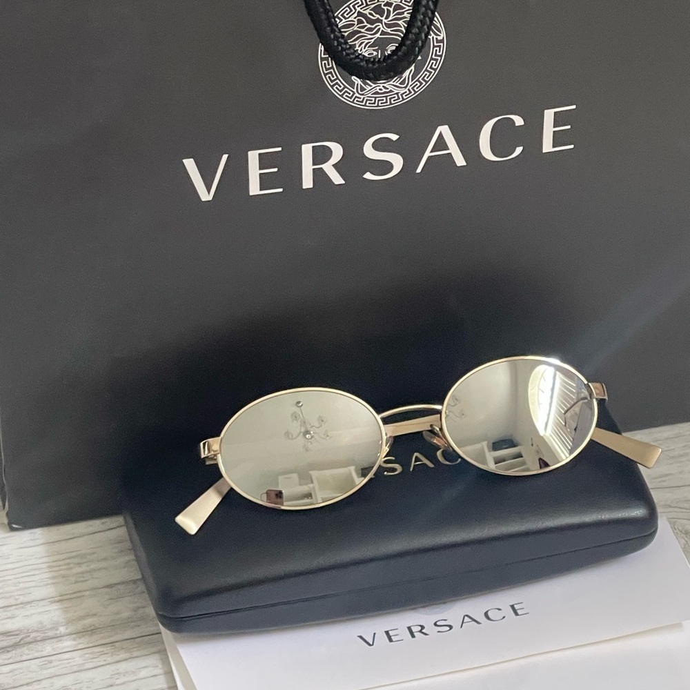 Beautiful  Versace Sunglasses feature mirrored silver lenses and gold rim.